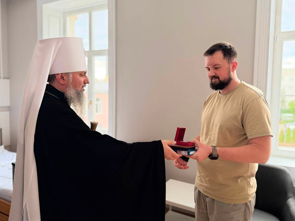 Митрополит Епіфаній передає нагороду українському захиснику